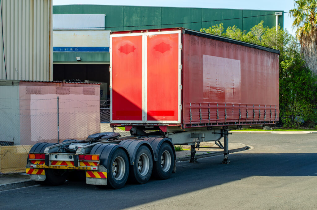 A semi-trailer container parked on an industrial lot in Australia, detached from its prime mover. Concept of freight transport, logistics, and commercial shipping infrastructure.